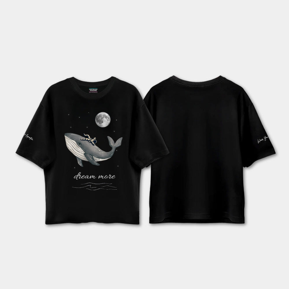 Black t-shirt with whale graphic and 'dream more' text on a white background